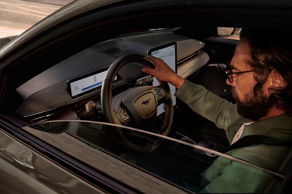 Person behind driving wheel of Mustang Mach-E