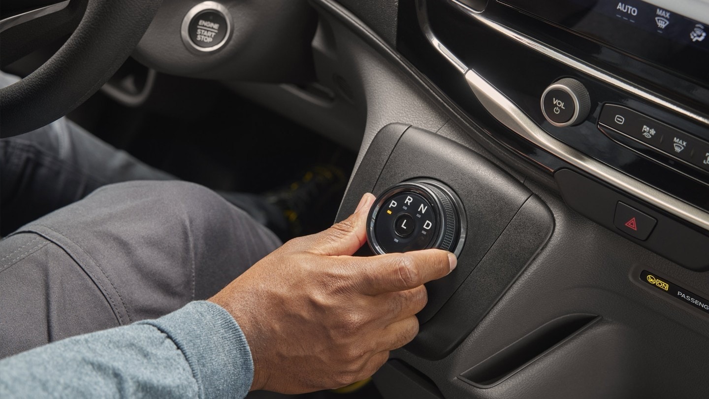 A person using the rotating gear select dial in the New Ford Transit