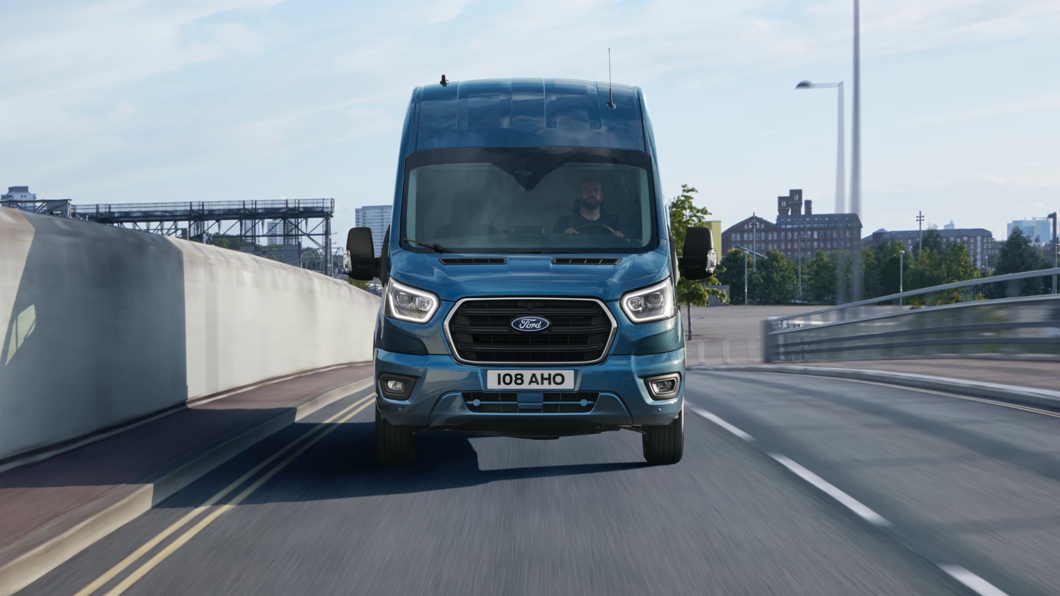 Front view of the new Ford Transit driving on a road